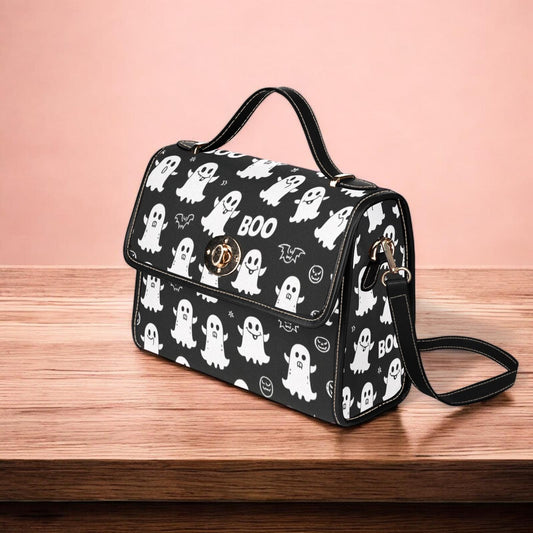 a black and white handbag with ghost print