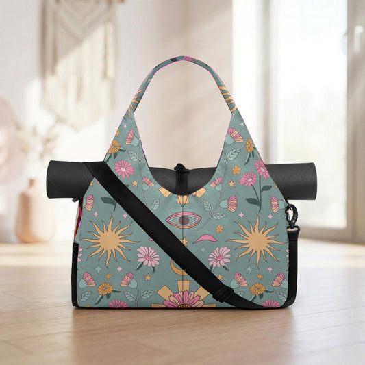 A colorful tote bag with a floral pattern and a strap, placed on a wooden floor against a white wall.