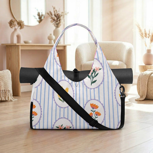 A white and blue striped tote bag with floral designs, placed on a wooden floor in a room with a mirror, vases, and a chair.
