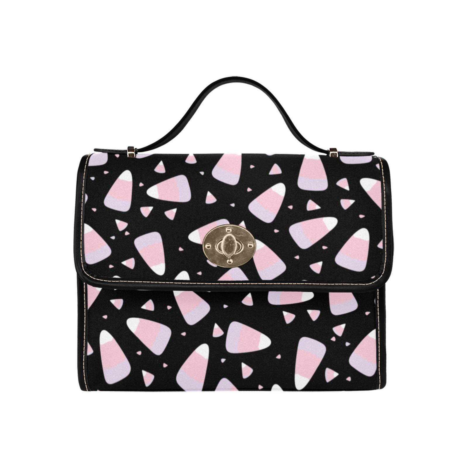 a black and pink handbag with hearts on it