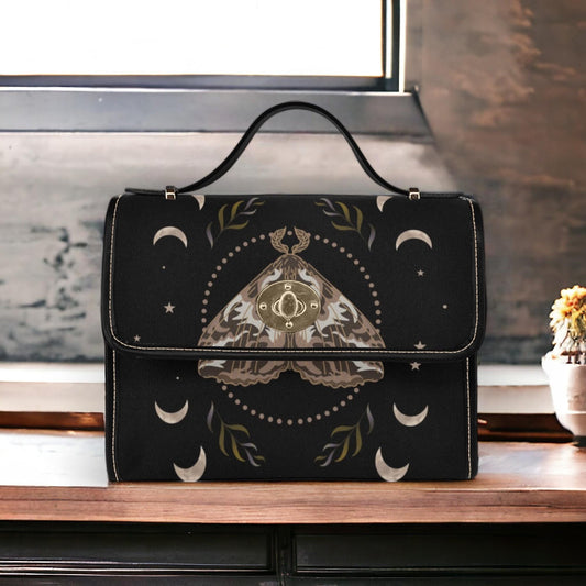 a black purse sitting on top of a wooden table