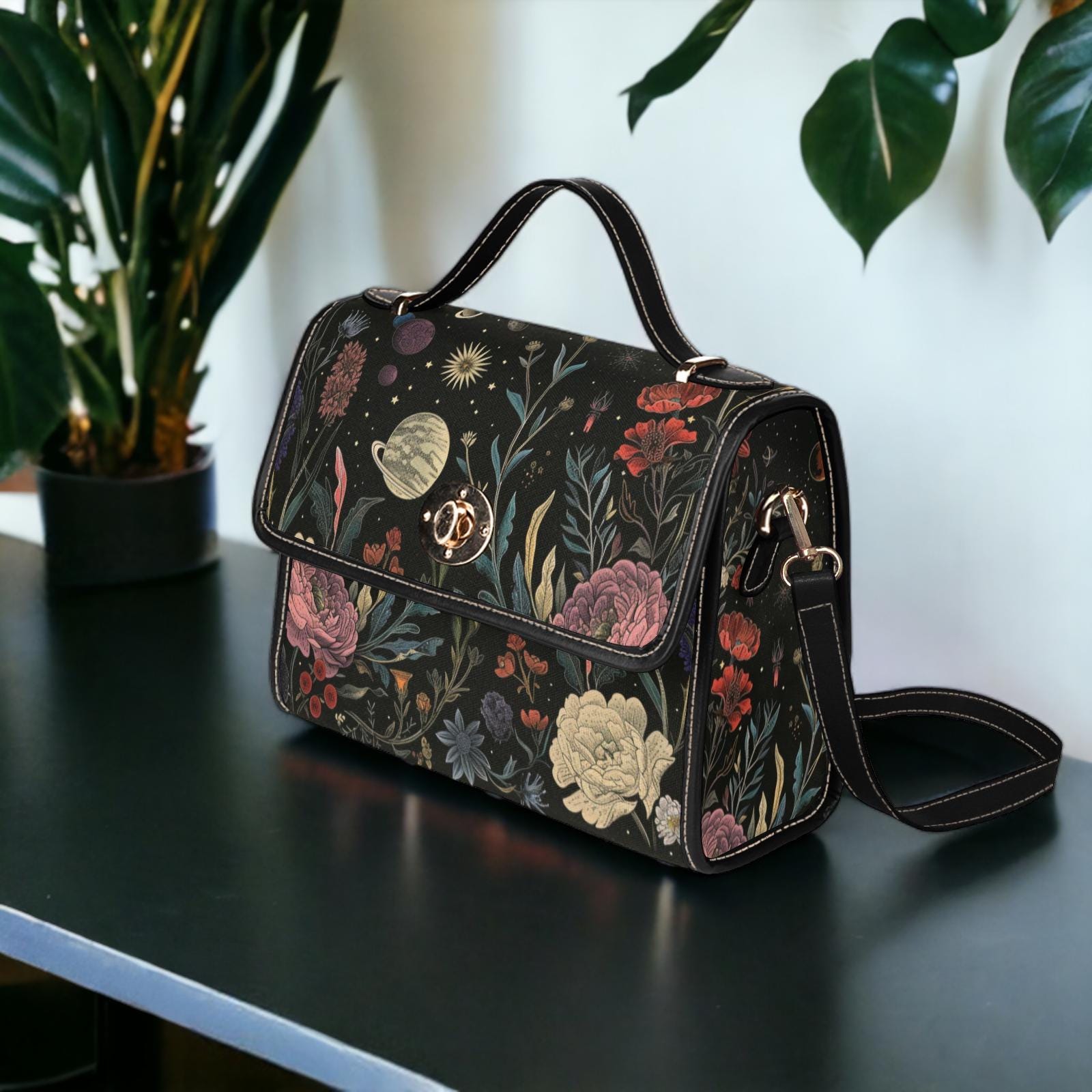 a handbag sitting on a table next to a potted plant