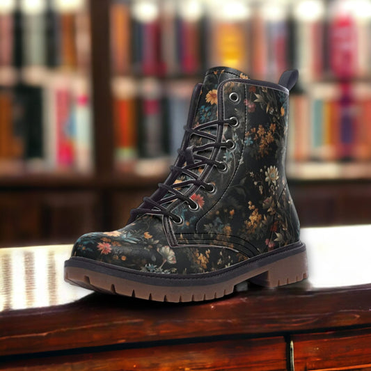 a pair of black boots sitting on top of a wooden table