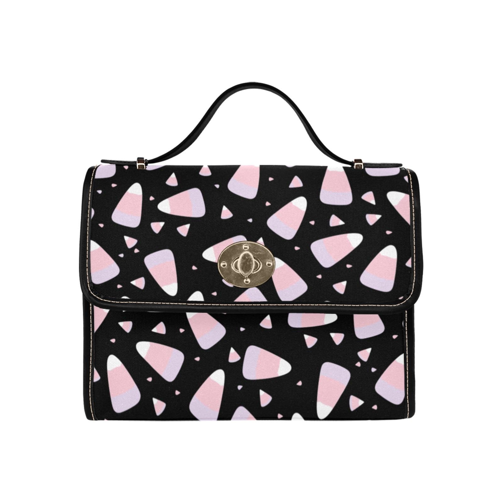 a black and pink handbag with hearts on it