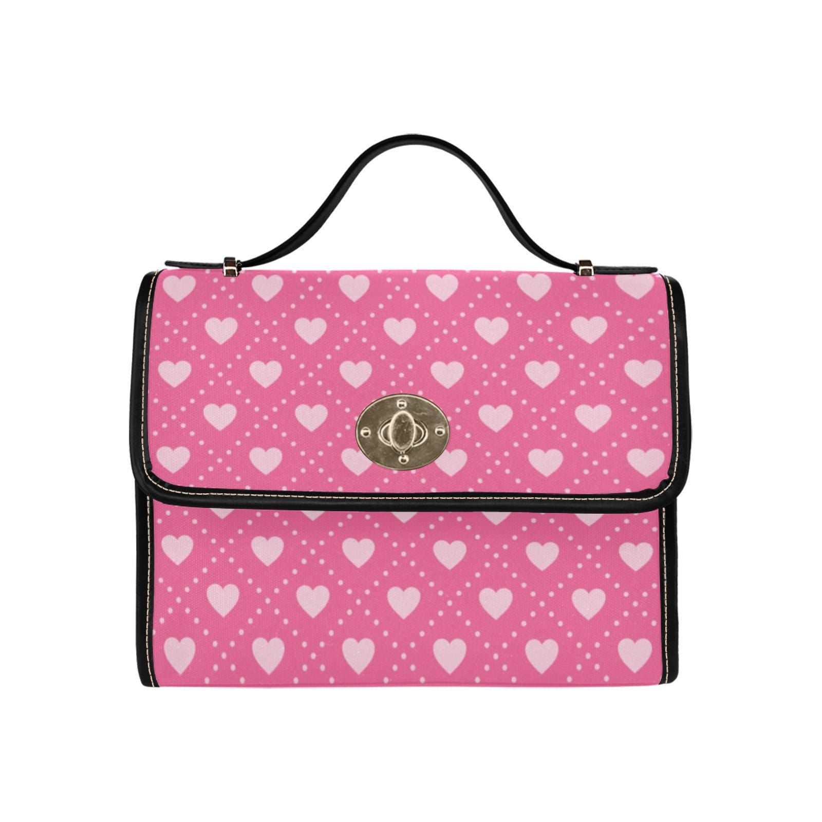 a pink and white purse with hearts on it