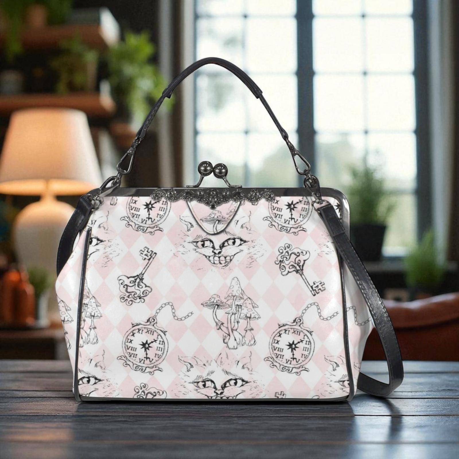 A handbag with a unique pattern of cats and clocks printed on it, sitting on a wooden surface.