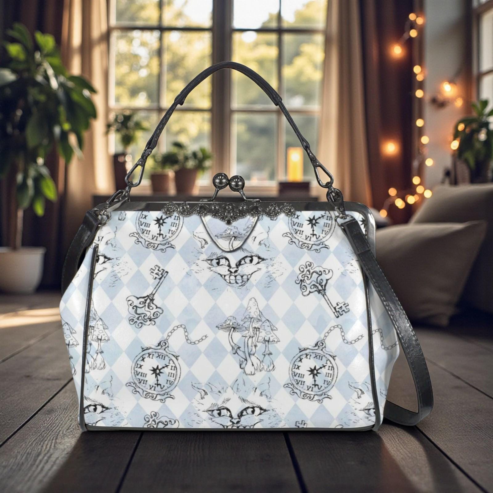 A handbag with a whimsical, cartoonish pattern of cats and clocks printed on it, placed on a wooden surface in front of a window with string lights.