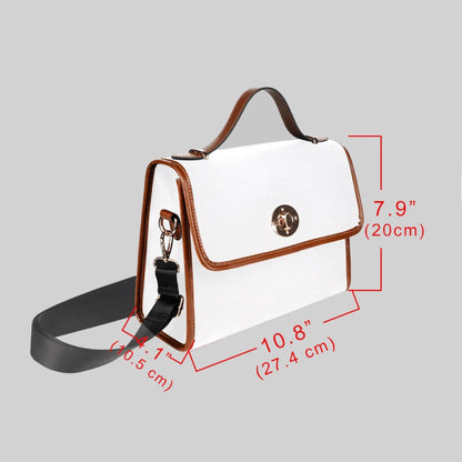 A white handbag with brown trim and a black strap, along with measurements indicating its dimensions.