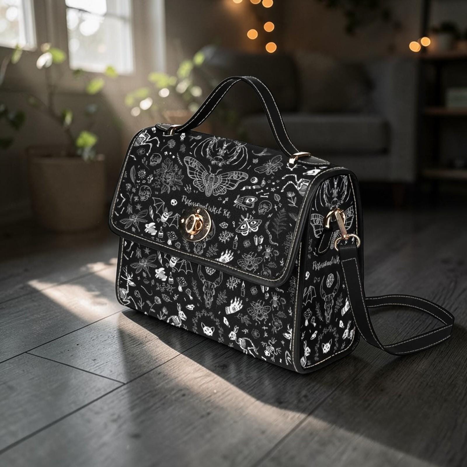 Goth moth-print handbag with its shoulder strap attached