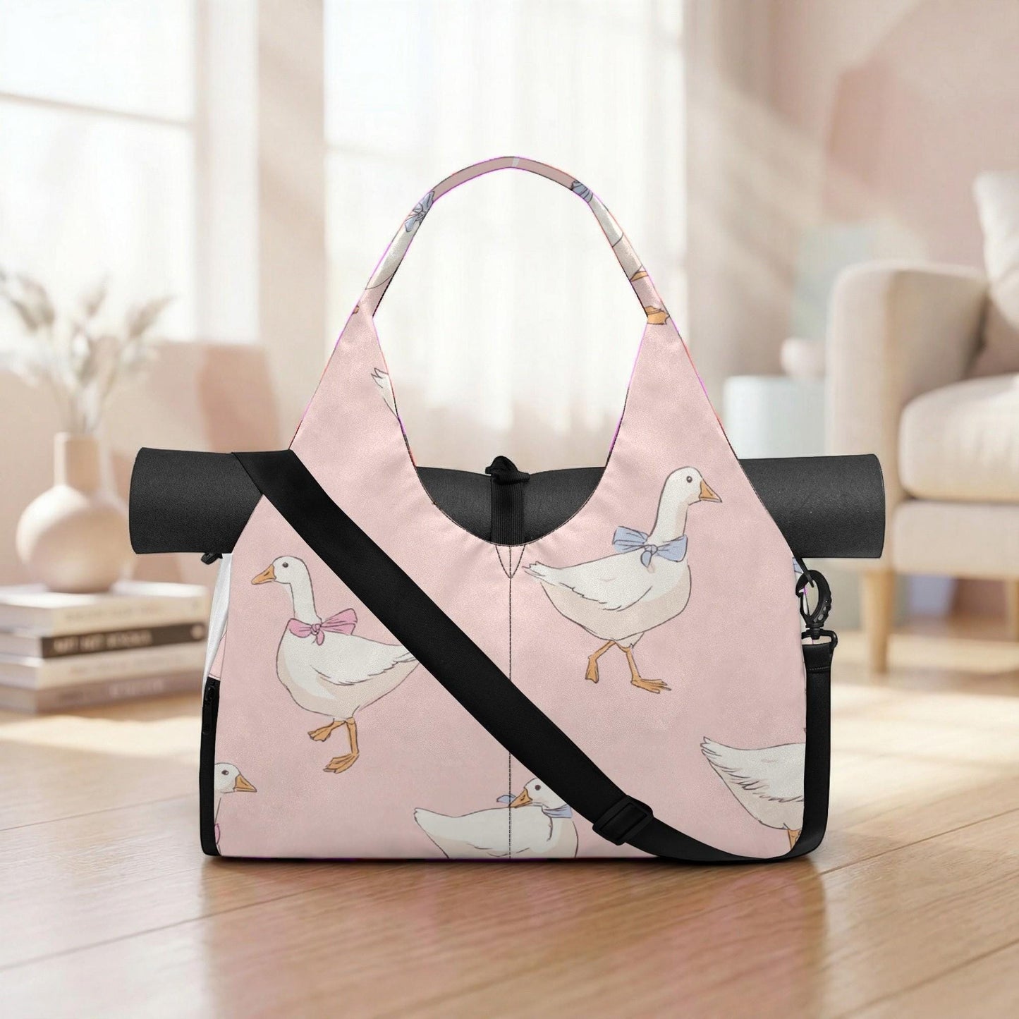 A pink tote bag with a pattern of white ducks and pink bows, placed on a wooden floor in a room with a couch and bookshelf in the background.
