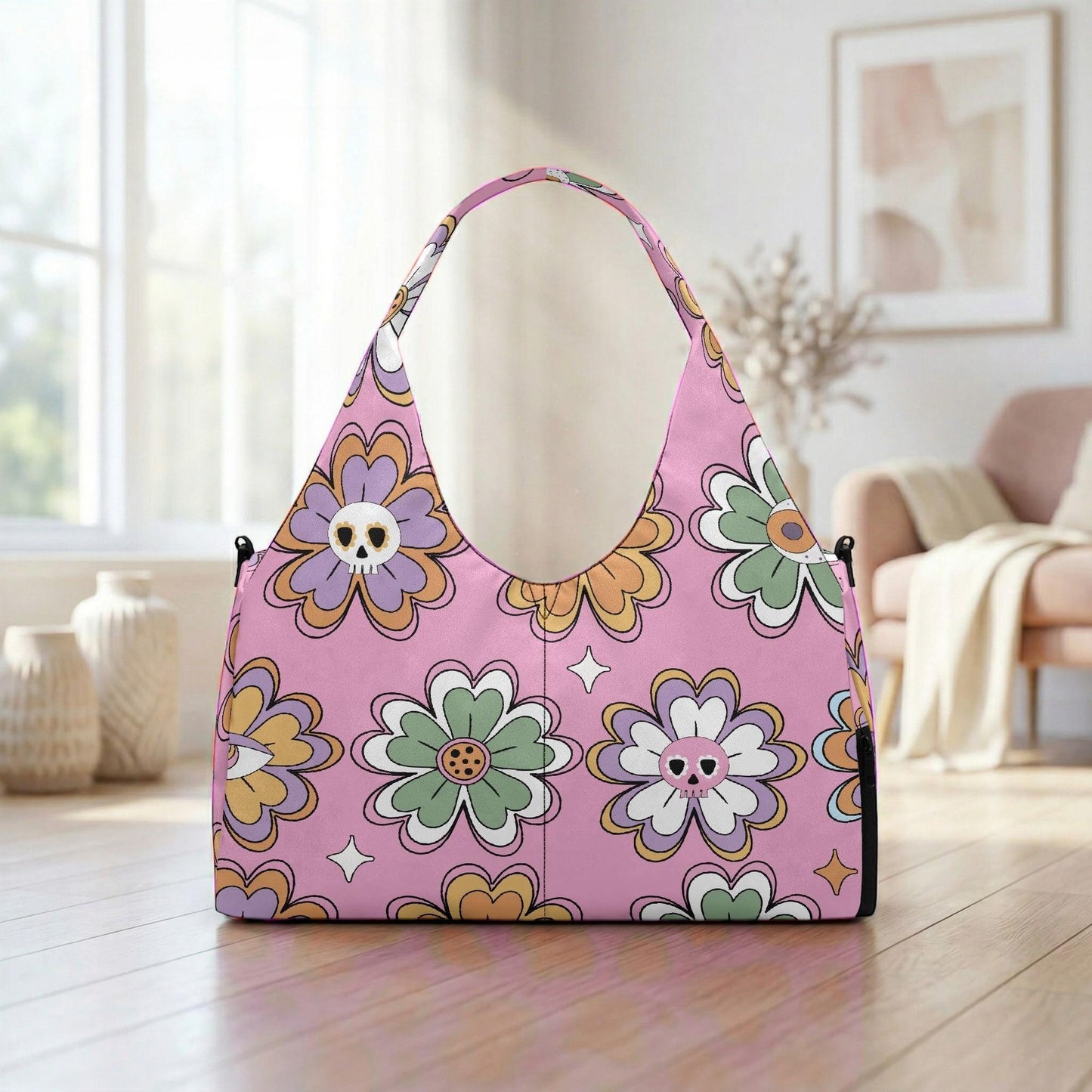 A pink handbag with a floral pattern is displayed on a wooden floor in a room with a window and a couch.