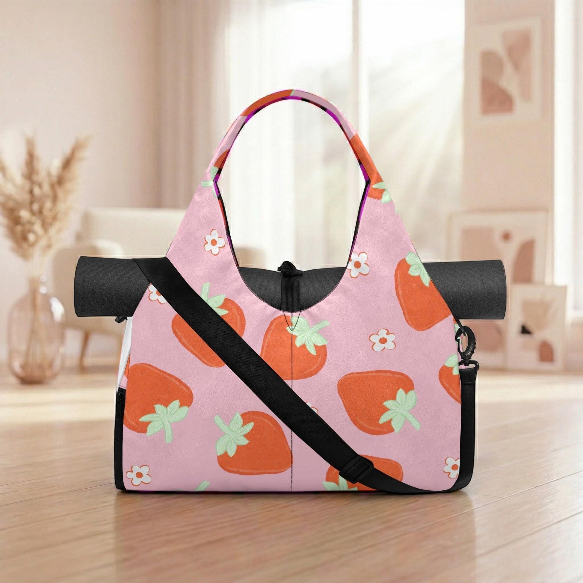 A pink yoga bag with a pattern of orange and green strawberries on a wooden surface.