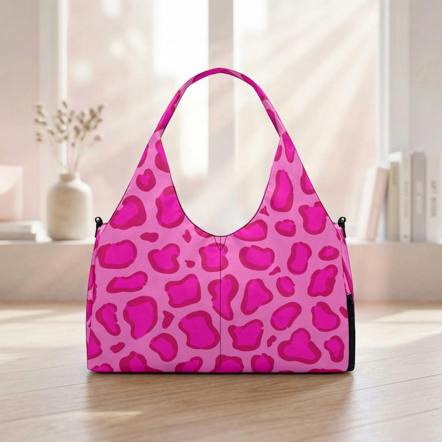 A pink leopard print handbag is displayed on a wooden floor in front of a window.