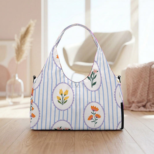 A handbag with a striped pattern and floral designs is placed on a wooden surface, with a vase and a chair visible in the background.