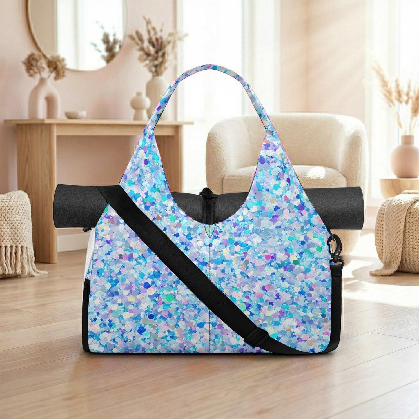 A colorful, patterned tote bag with a black strap is displayed on a wooden floor in a room with a mirror, vases, and a chair.