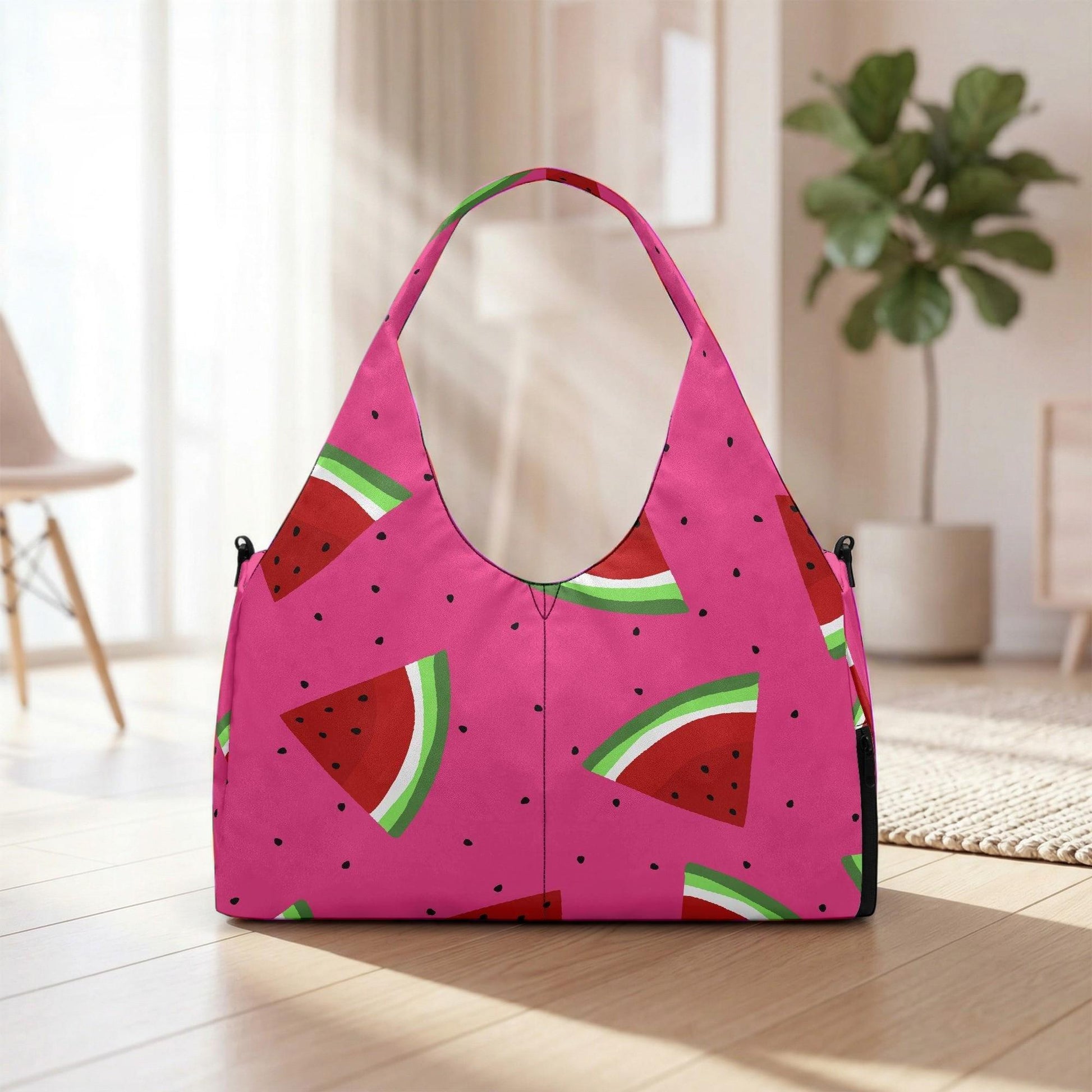 A pink handbag with a watermelon pattern is displayed on a wooden floor in a room with a potted plant in the background.