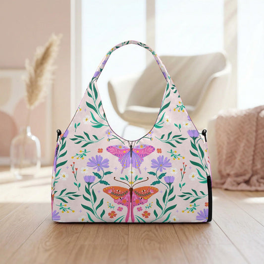 A handbag with a floral pattern and butterflies printed on it, placed on a wooden surface.