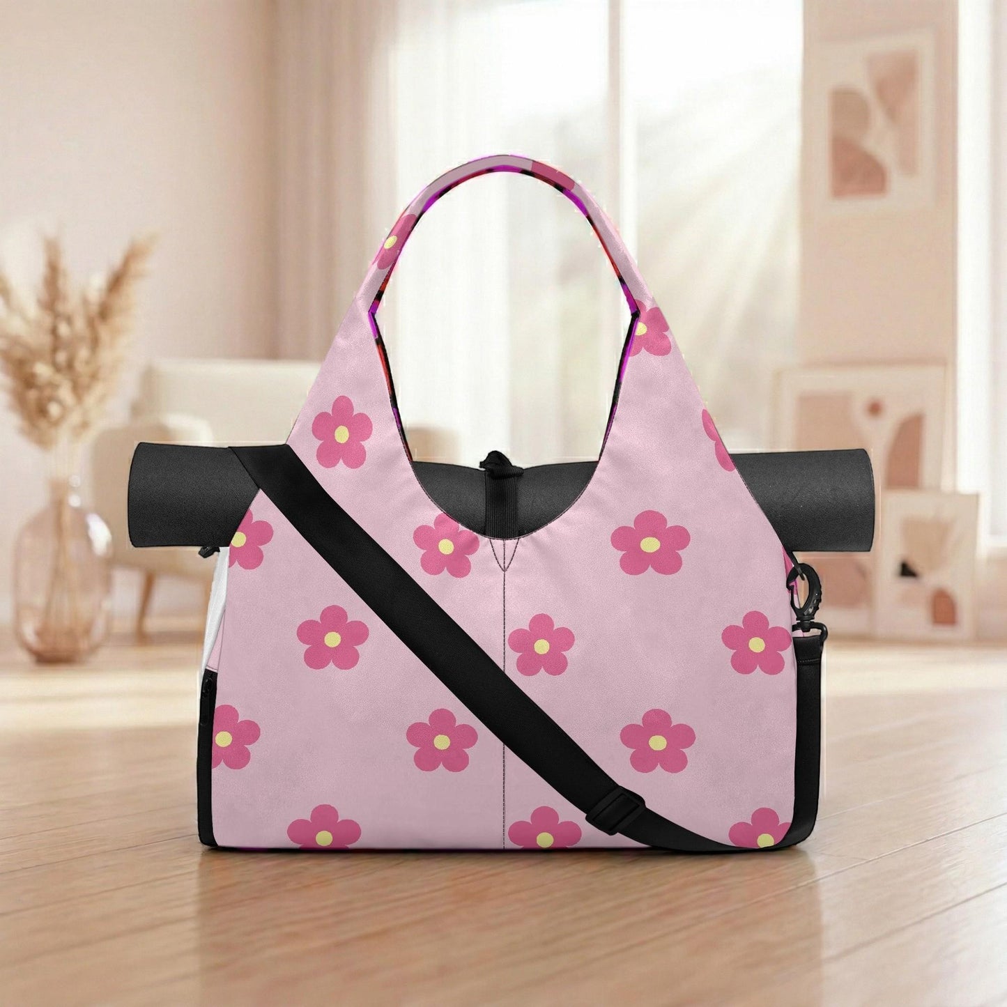 A pink tote bag with a floral pattern is placed on a wooden surface, with a vase of dried flowers in the background.