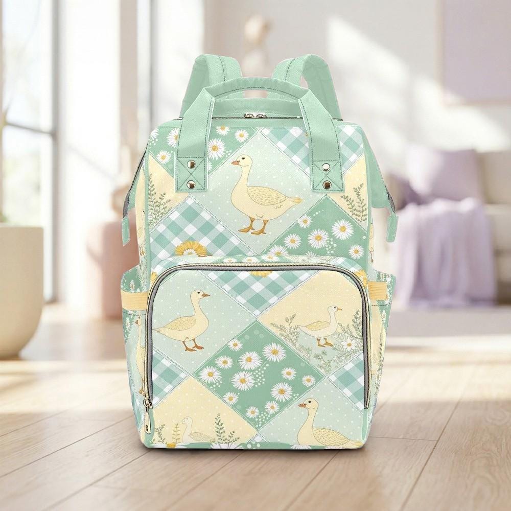 A green and white patterned backpack with a design of ducks and flowers on a wooden floor.