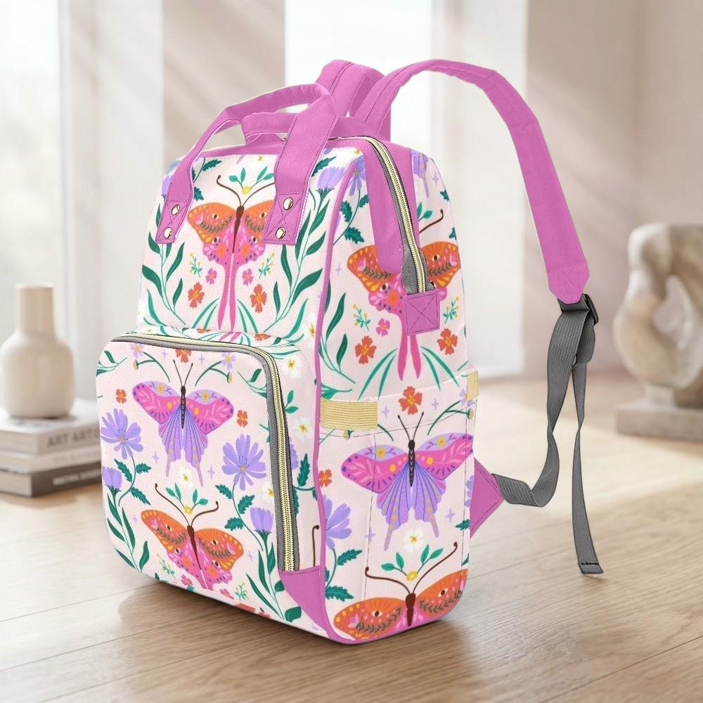 A colorful backpack with a floral pattern and butterflies printed on it, sitting on a wooden surface.