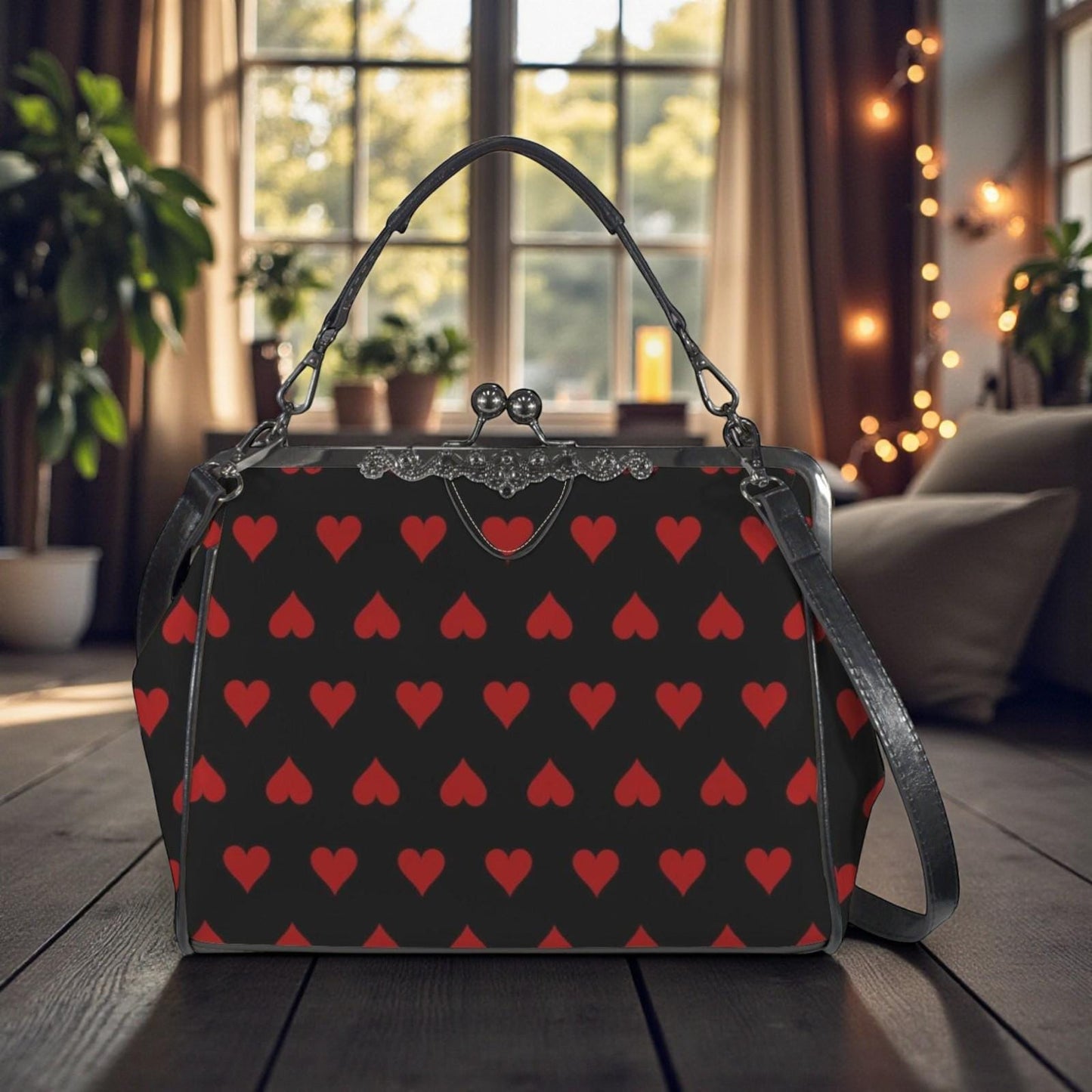 A black purse with a red heart pattern is displayed on a wooden surface, with a window and plants visible in the background.