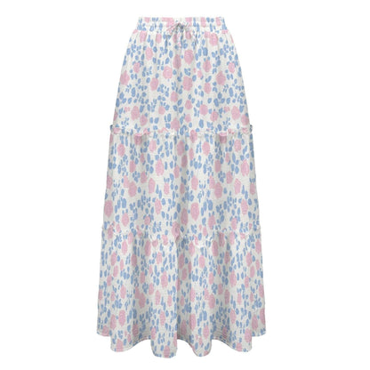 Studio shot of the high waist tiered maxi skirt displaying the white fabric with pink roses, blue leaves, and a drawstring waist.