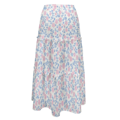 A long white tiered maxi skirt patterned with pink roses and blue leaves on an elastic waistband.