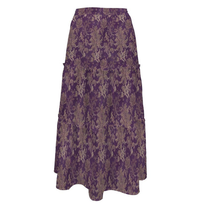 A long, high-waisted tiered maxi skirt made of deep purple fabric featuring an ornate golden damask pattern.