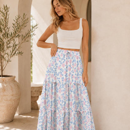 Close-up of the blonde model posing in the white crop top and pink and blue floral tiered maxi skirt.