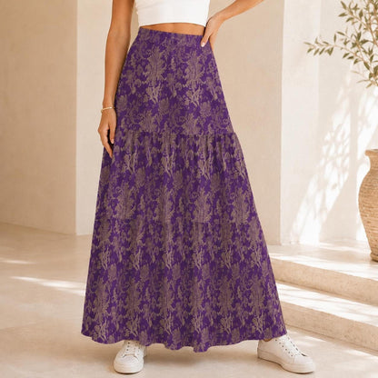 Close-up view of a purple tiered maxi skirt with a beige damask pattern worn with a white top.