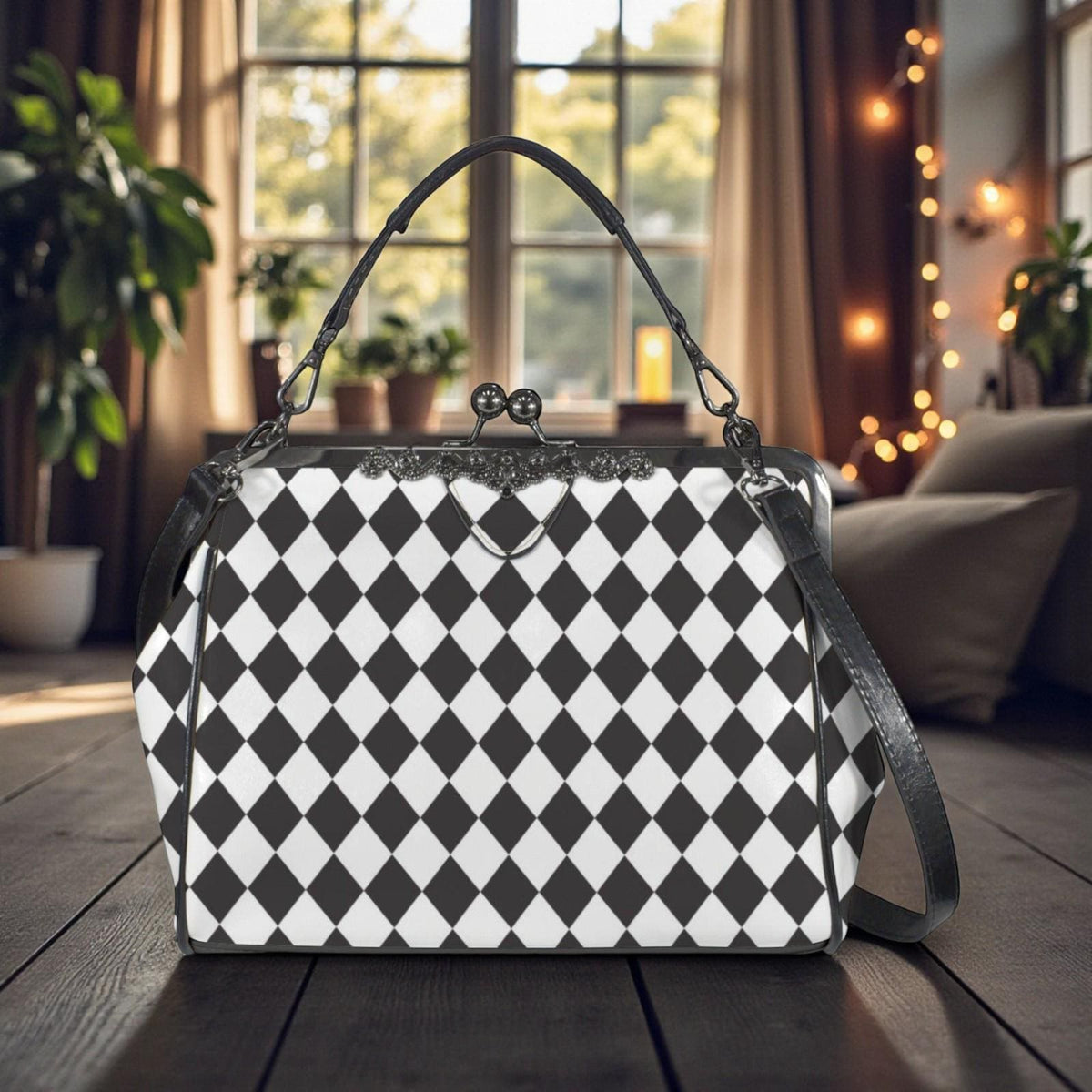 A black and white checkered handbag with a black leather strap is displayed on a wooden surface, with a window and plants visible in the background.