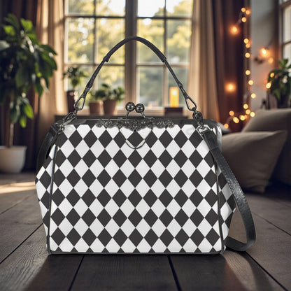 A black and white checkered handbag with a black leather strap is displayed on a wooden surface, with a window and plants visible in the background.