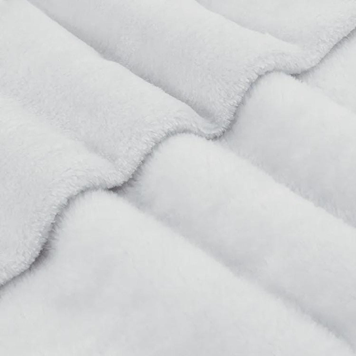 A close-up macro view of soft, plush white sherpa fleece fabric folded in gentle waves.