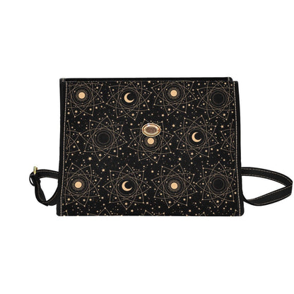 Flat lay view of the front flap of the black sun and moon bag on a solid white background.