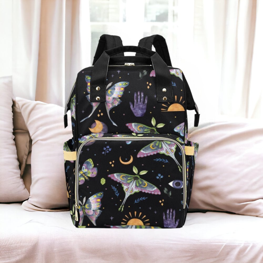 a backpack sitting on top of a bed next to pillows
