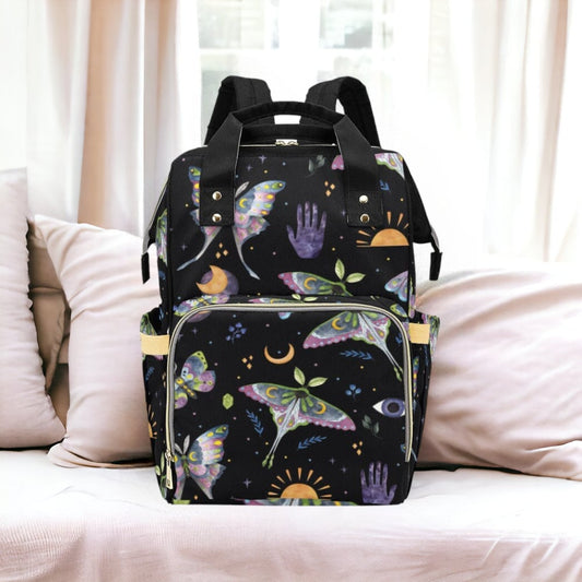 a backpack sitting on top of a bed next to pillows