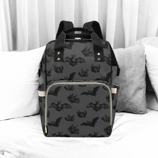 a black and white photo of a backpack on a bed