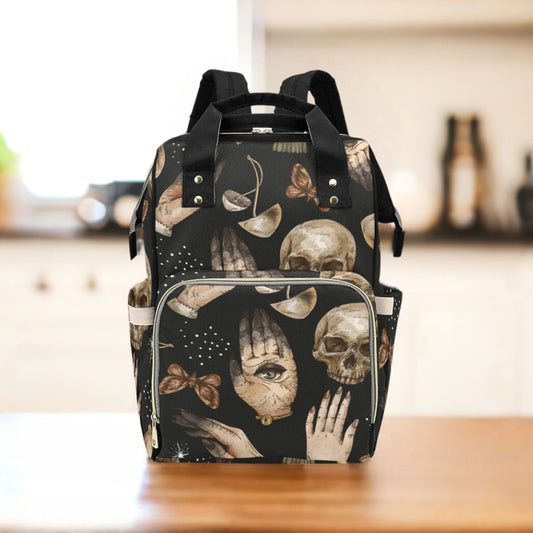 a black backpack with skulls and hands on it