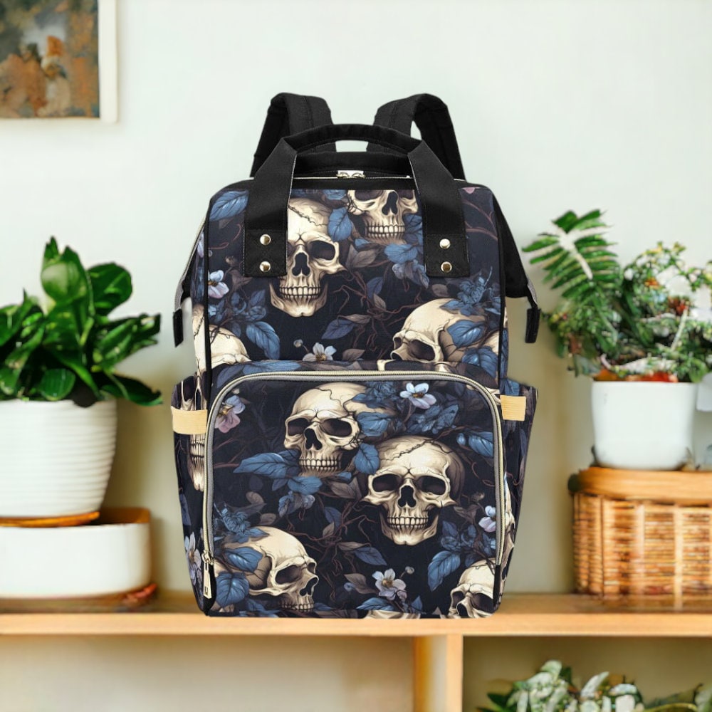 a backpack with skulls and flowers on it