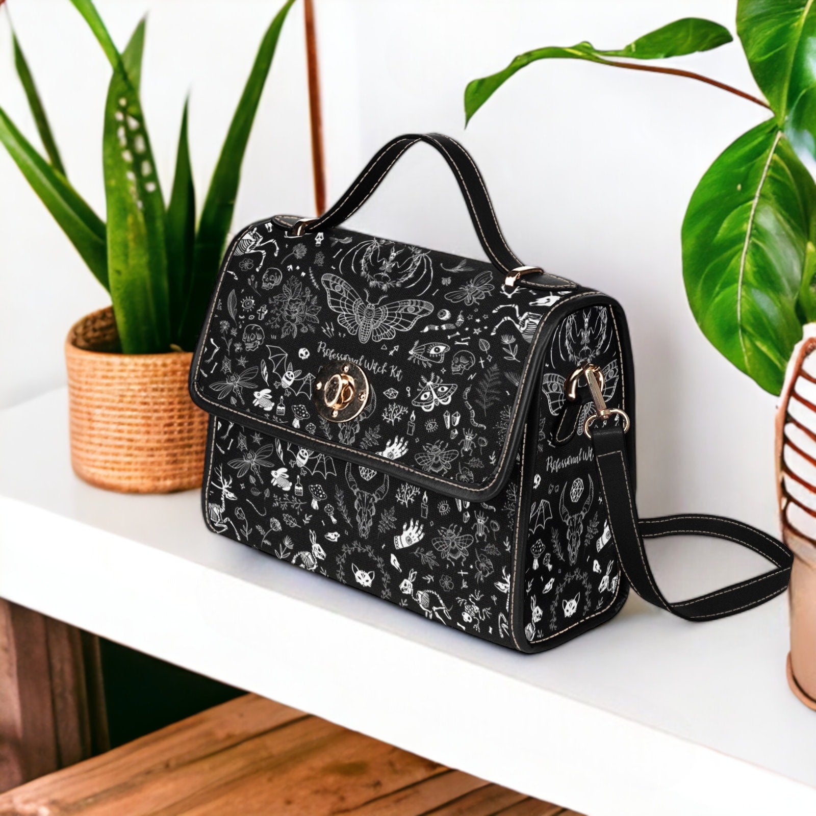 a black and white purse sitting on top of a table