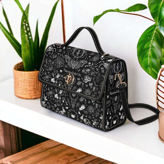 a black and white purse sitting on top of a table