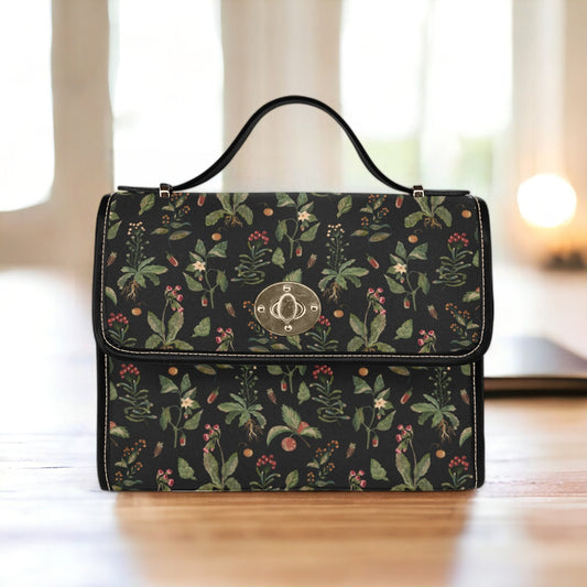 a black floral purse sitting on top of a wooden table
