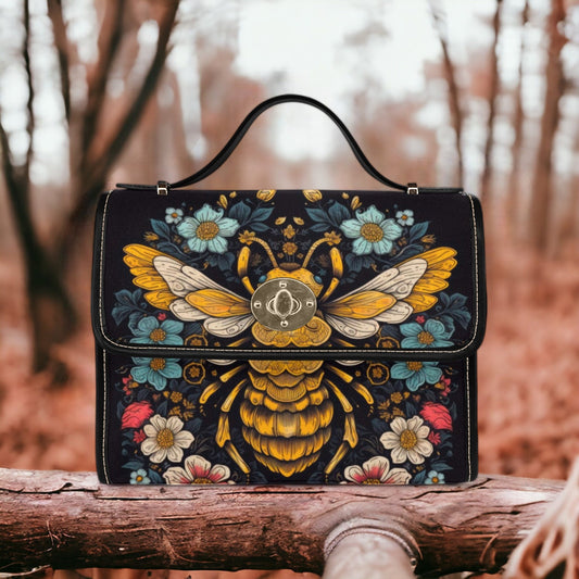 a bee painted on a black leather purse