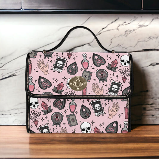 a pink purse with skulls and skulls on it