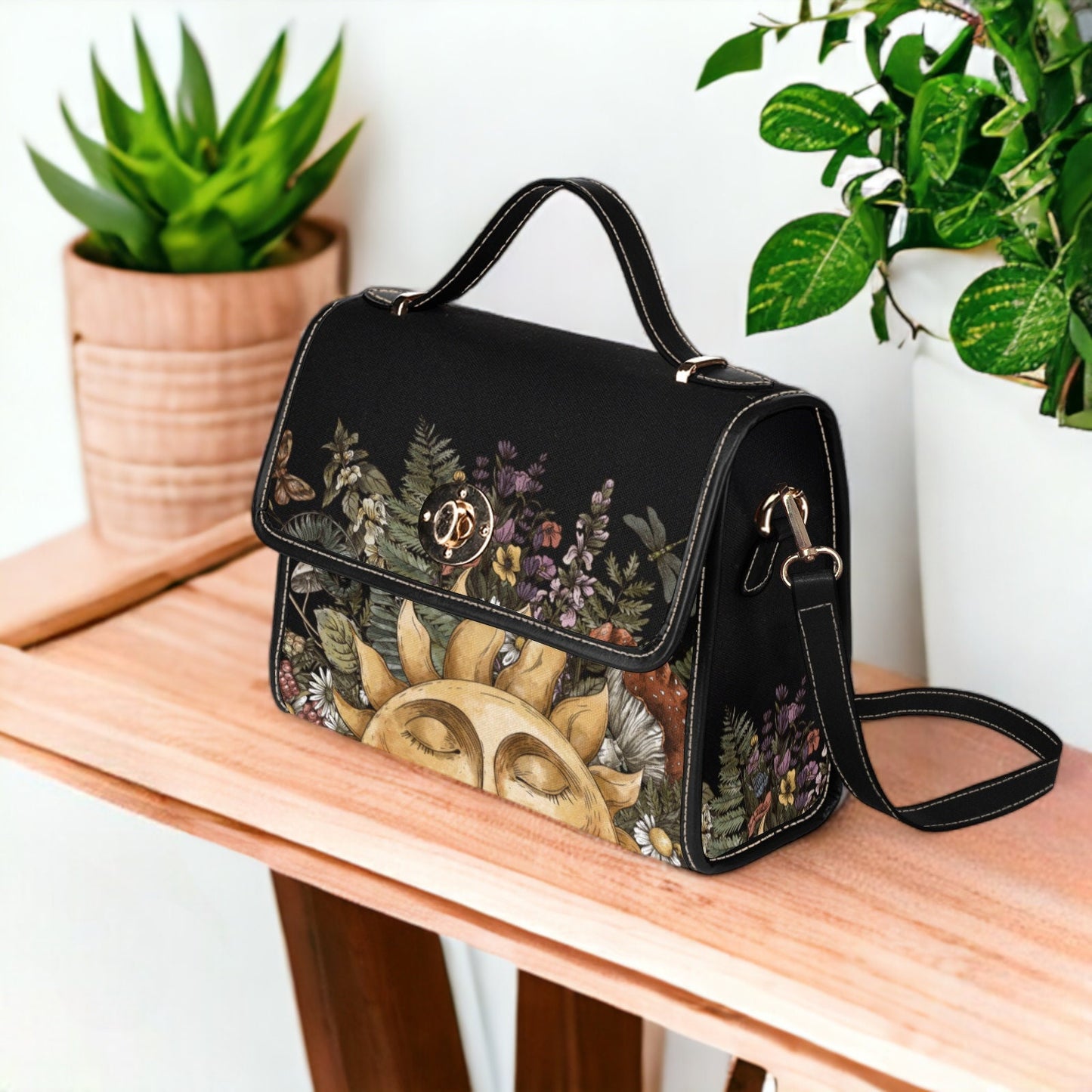 a black handbag with a floral design on it