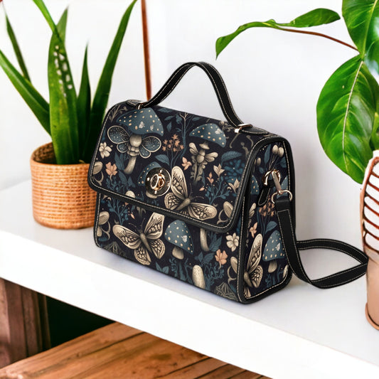 a purse sitting on top of a table next to a potted plant