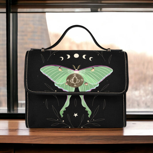 a black purse with a green butterfly painted on it