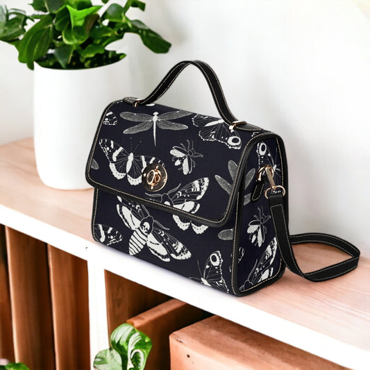 a black and white handbag sitting on top of a table